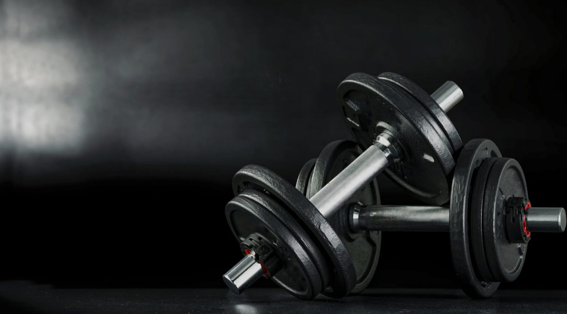 Dumbbells in a dark training studio